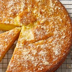 a cake that is on a cooling rack with some powdered sugar over it's edges