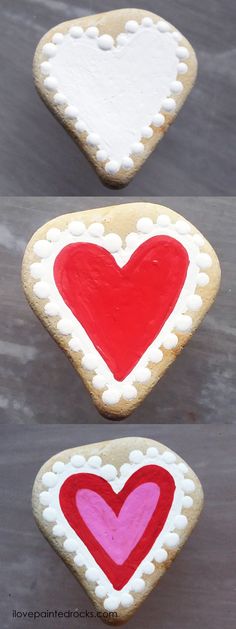 three heart shaped cookies on top of each other, one with red and white frosting