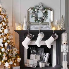 a christmas fireplace with stockings and presents on it