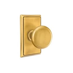 a brass plated door handle with a round knob