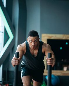 a man is doing push ups with two poles