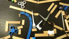 construction materials laid out on a table with scissors and pegs to make a bridge