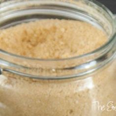 a glass jar filled with sand sitting on top of a table