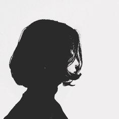 the silhouette of a woman's head against a white background