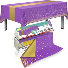 a purple table cloth with gold dots on it and a roll of tape under the table