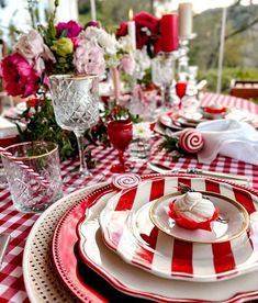 a red and white table setting with candy canes