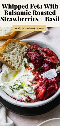 a white bowl filled with bread and cranberry sauce on top of a table