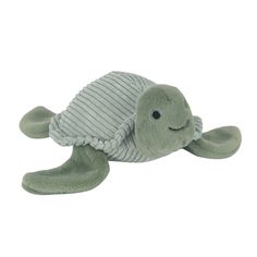 a stuffed turtle with a sweater on its back and eyes closed, laying down in front of a white background