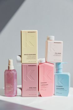 several different types of skin care products on a white surface with sunlight coming through the window