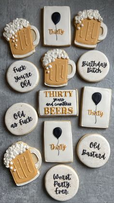 decorated cookies are arranged in the shape of beer mugs