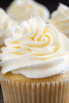 several cupcakes with white frosting on top