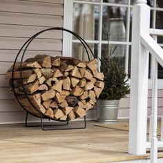 a stack of firewood sitting on top of a wooden porch