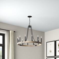 This 12-light wagon wheel-style chandelier has a bold look that's great for making a statement in larger spaces. It's made from steel and features a single tier of twelve candle-style bulb bases in a black finish. We love the contrasting finish on the frame, which adds the rustic look of wood set against an otherwise industrial-inspired design. This fixture hangs from a sloped ceiling-adaptable canopy and features an adjustable height, as well as compatibility with dimmer switches and smart bulb Wood Wagon Wheel Chandelier, Remington Iron Round Chandelier, Black And Gold Wagon Wheel Chandelier, Capital Lighting Greyson 5 Light 29" Wide Taper Candle Chandelier, Smart Bulbs, Kichler Elula 6-light Anvil Iron And Distressed Antique Grey Farmhouse Chandelier, Smart Bulb, Farmhouse Chandelier, Wagon Wheel