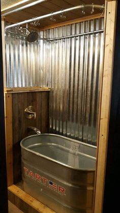 a large tub sitting inside of a bathroom next to a metal wall mounted faucet