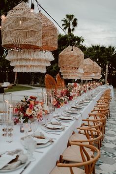 a long table is set with plates and place settings