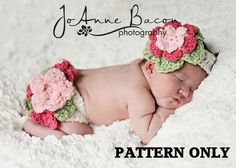 a newborn baby wearing a crocheted flower headband