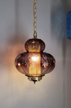 a light hanging from a ceiling in a room