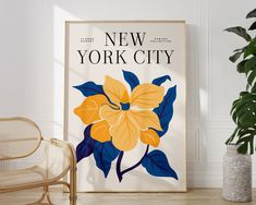 a poster with the words new york city on it next to a chair and potted plant