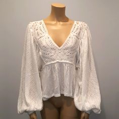 Free People Baby Doll, Long Puffy Sleeve, Crochet Top. I Have 1 Size Medium And 1 Size Xs. Brand New Without Tags. I Get Several Free People Items From My Source And Sometimes The Tags Are Not Attached And There Is A Line Through The Label In Order To Avoid Returns At Major Retail Stores. This Boho-Chic Top Looks Good With Shorts, Jeans, Skirts, And Over A Bikini. It Has A V-Neckline With Crochet Detailing And An Elastic Cuff Sleeve Bottom. White V-neck Crochet Top For Brunch, Fitted Bohemian Tops With Broderie Anglaise, White Pointelle Knit Crochet Top V-neck, White V-neck Pointelle Crochet Top, White Crochet V-neck Top, Fitted Long Sleeve Crochet Top For Brunch, White Cotton Pointelle Knit Blouse, V-neck Cotton Top With Crochet Lace, Cotton V-neck Top With Crochet Lace