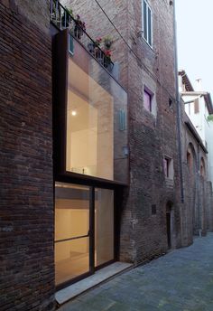 an alley way with brick buildings and windows