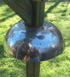 a metal object sitting on top of a lush green field