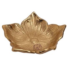 a gold flower shaped bowl on a white background