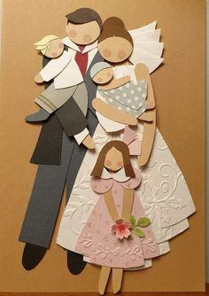 an image of a family made out of paper on a brown card with white and pink accents