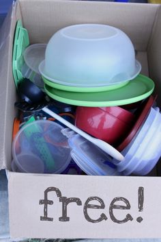 a cardboard box filled with plastic containers and bowls that says free on the side,