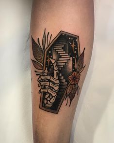 a tattoo on the leg of a person with stairs and flowers around it, in black and white