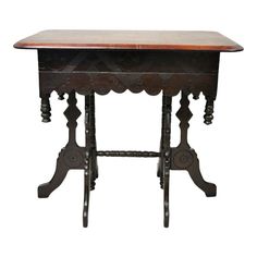 an old wooden table with ornate carvings on the top and bottom, against a white background