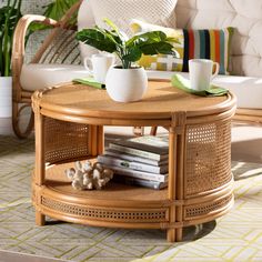 a wicker coffee table with two cups on top and books stacked in front of it