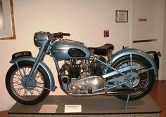 an antique motorcycle on display in a museum