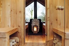 a wood burning stove sitting inside of a wooden cabin