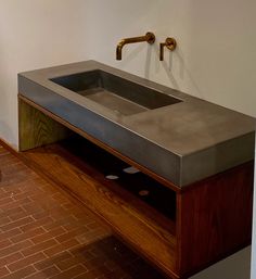 a bathroom sink sitting on top of a wooden counter