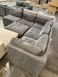 a large couch and ottoman in a warehouse