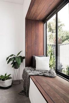 a wooden window sill sitting next to a potted plant