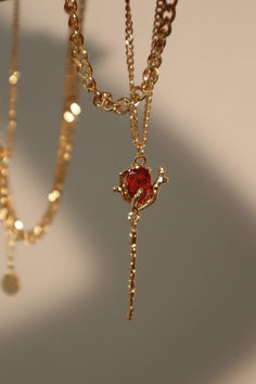 Flicker goodbye to dull and stand out in our shimmering gold chain. With the right lighting, our red gem adds a subtle pop of shine to your ensemble. This unique necklace makes the perfect layering chain and an even better gift for her. Ethereal Jewelry, Pretty Jewelry Necklaces, Magical Jewelry, Jewelry Accessories Ideas, Layer Necklace, Dope Jewelry, Classy Jewelry, Fancy Jewellery, Jewelry Lookbook