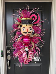 the front door is decorated with pink and gold decorations, including a nutcracker