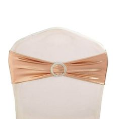 the back of a white chair with a rose gold sash on it's belt