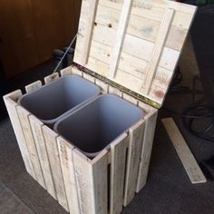 an open wooden box sitting on top of a floor