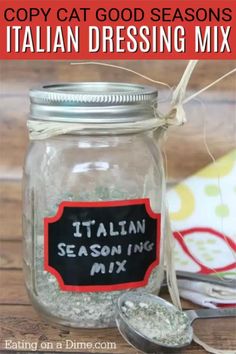 a mason jar filled with italian seasoning mix next to a spoon and napkin on a wooden table