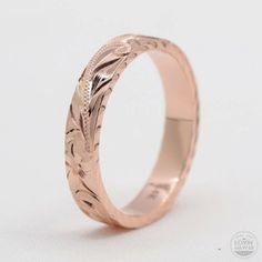 a wedding ring with an engraved design on it