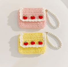 two crocheted purses sitting next to each other on a white table top