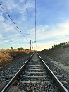 the train tracks are running parallel to each other and there is no one on them