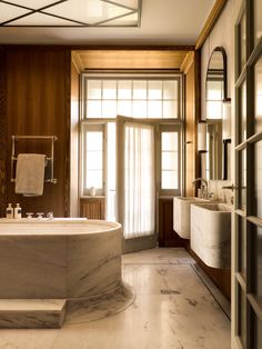 an elegant bathroom with marble and wood accents