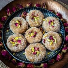 a bowl filled with powdered donuts covered in flowers