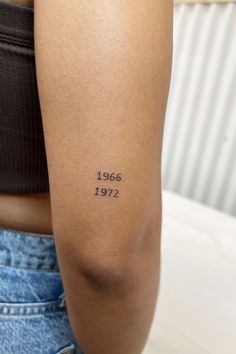 a woman with a tattoo on her arm that reads, 1965 - 1971 in black ink