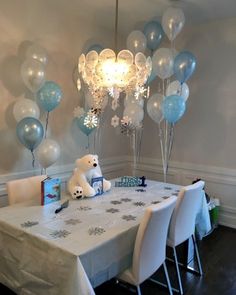 a white table with blue and silver balloons