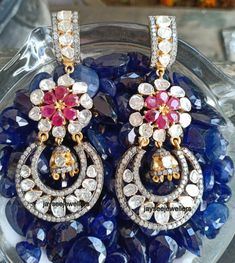 Item-SilverBrand : Jaysee JewellersCountry/Region of Manufacture: IndiaMetal Purity: 925 parts per 1000Main Stone Color - whiteMain Stone :Polki DiamondSecondary Stone : Ruby,Pave DiamondGross Weight - 26.00 Gram Length : 67 mmWidth : 29 mmPolki Diamond & Ruby Gemstone Dangle Earrings, Silver Jewelry.Special customize for Mother's day, Anniversary, Birthday Gift, Valentine, Christmas. Luxury Rose Cut Diamond Chandelier Earrings For Wedding, White Diamond Multi-stone Earrings, Silver Diamond Jhumkas For Reception, Hand Set Diamond Teardrop Bridal Earrings, Cubic Zirconia Pendant Earrings For Wedding, Elegant Ruby Diamond Earrings For Wedding, Luxury Multi-stone Wedding Earrings, Luxury Multi-stone Earrings For Wedding, Wedding Drop Earrings With 17 Jewels