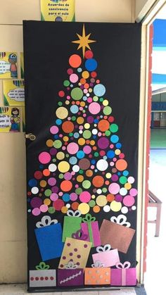 a decorated christmas tree door with presents on the front and side, as well as an ornament